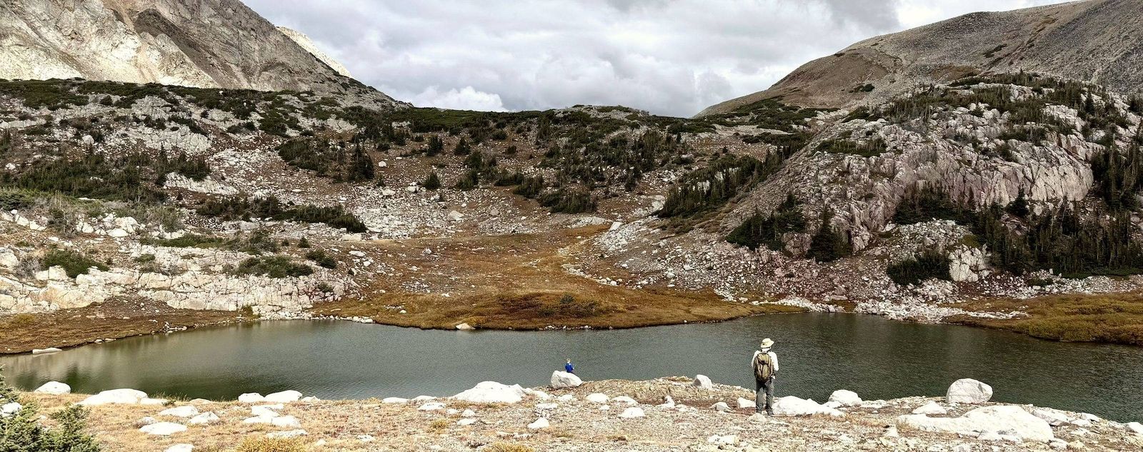 A wide alpine lake below a mountain range